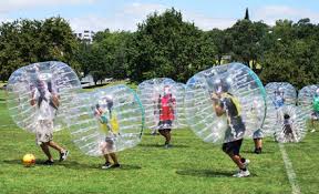 kids in field playing bubble soccer | Fun Services Midwest