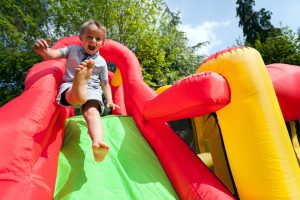 Young boy going down inflatable slide | Fun Services Midwest