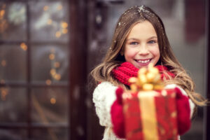 Girl With Beautifully Wrapped Christmas Present - Fun Services Midwest