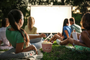 Teens watching an outdoor movie on sheet | Fun Services Midwest