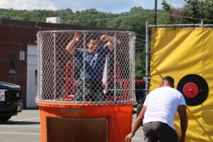 Two boys playing in water dunk tank at event | Fun Services Midwest