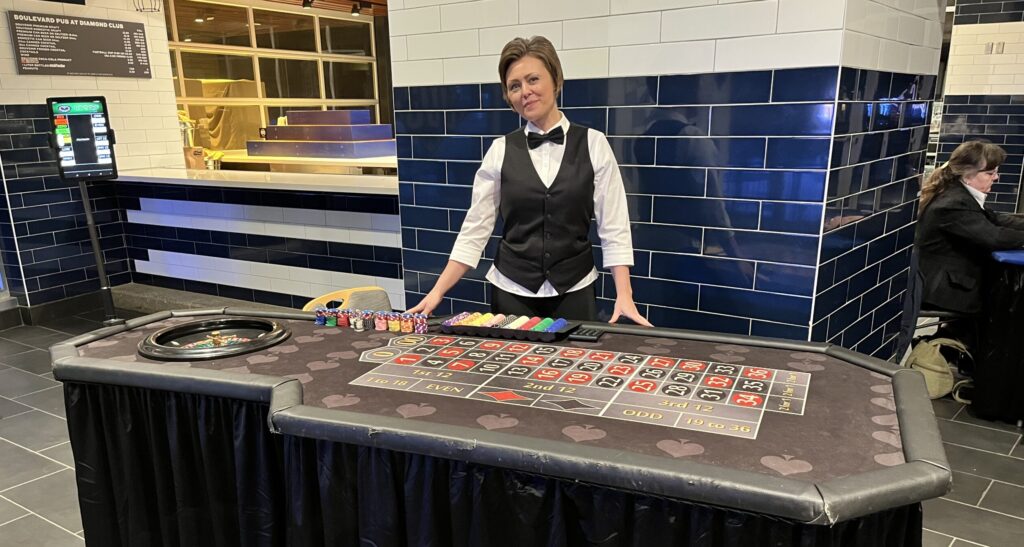 casino dealer at table | FSMW